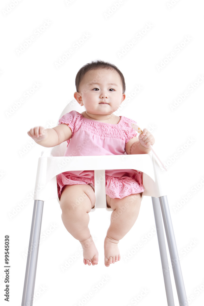 Lovely baby girl on baby high chair 