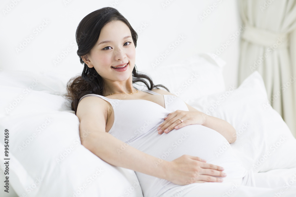 Pregnant woman resting in bed