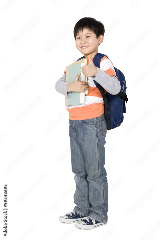 A young boy holding books and giving a thumbs up