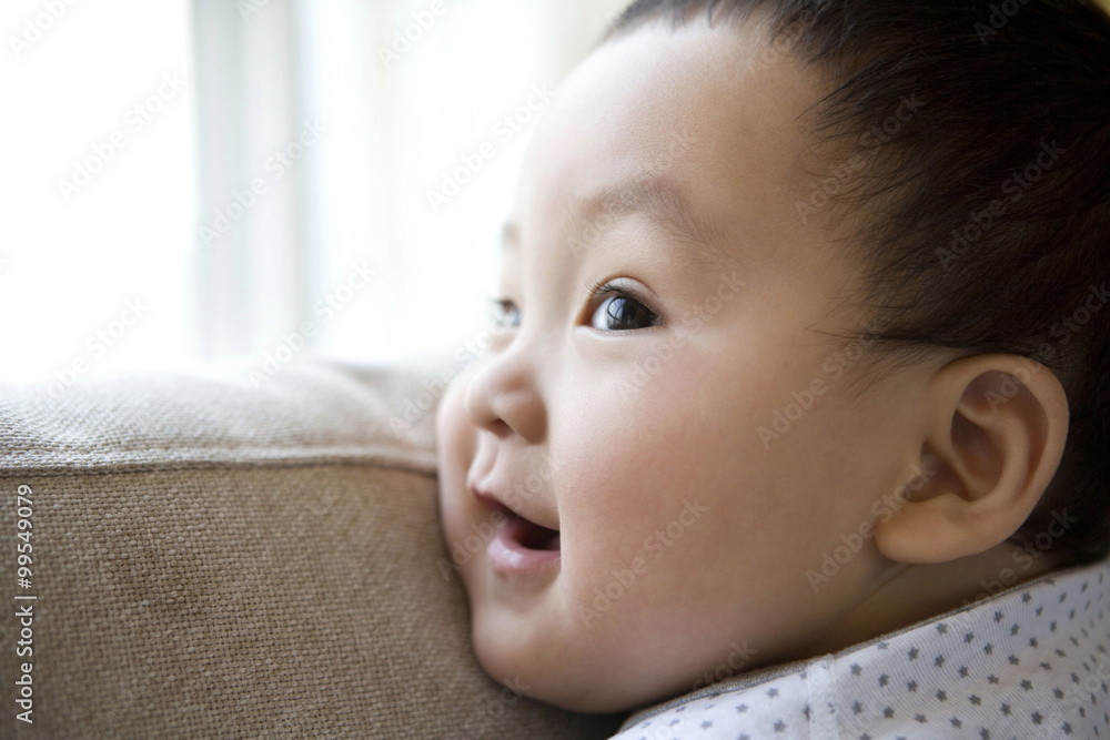 Infant on sofa back