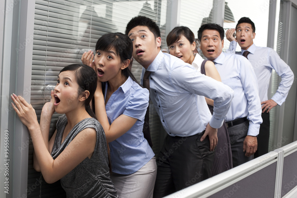 Colleagues Holding Glasses Against the Wall