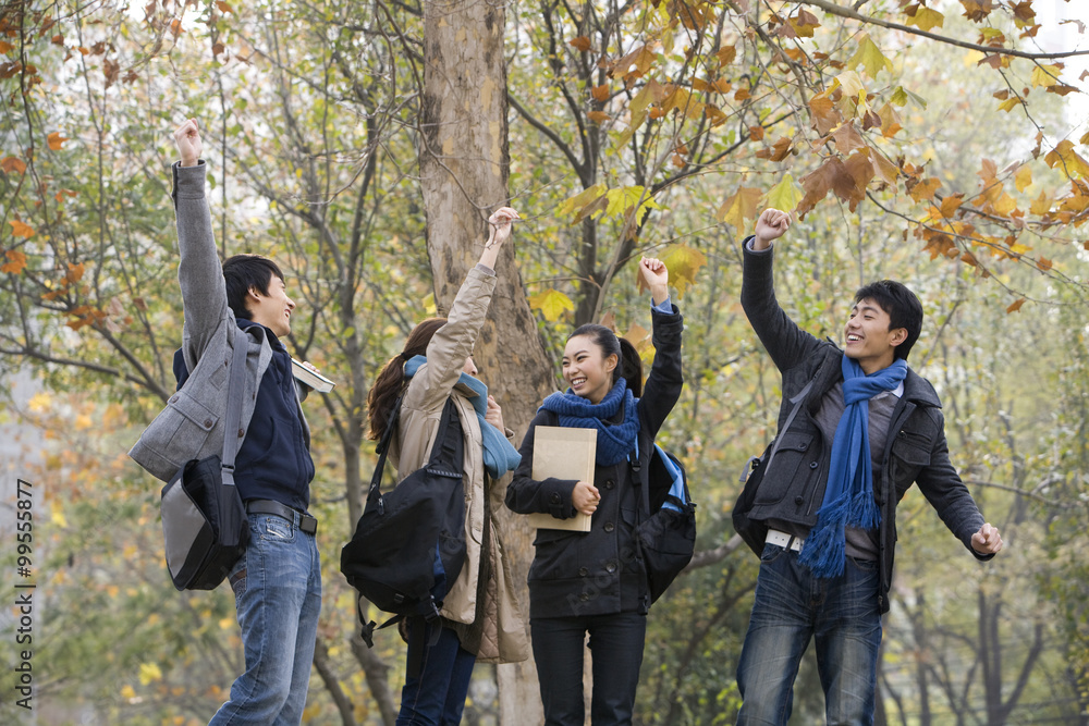 Friends celebrating with arms raised in excitement