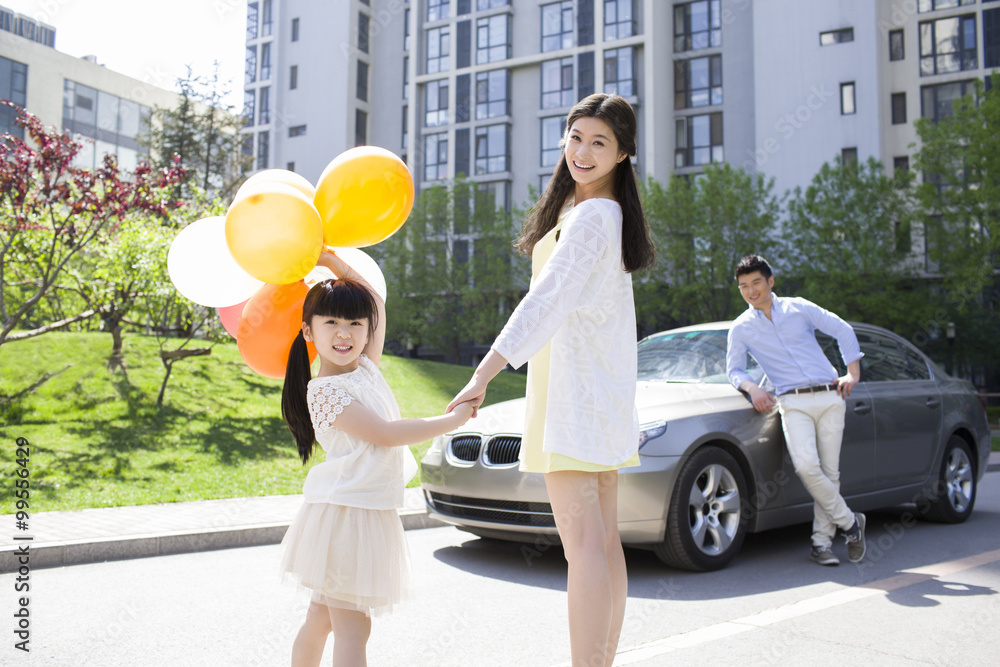 Happy young family and car