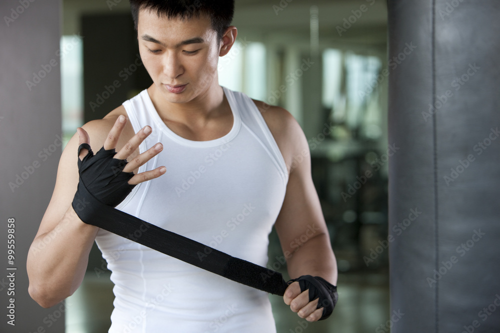 Young Man Putting on Hand Wrap