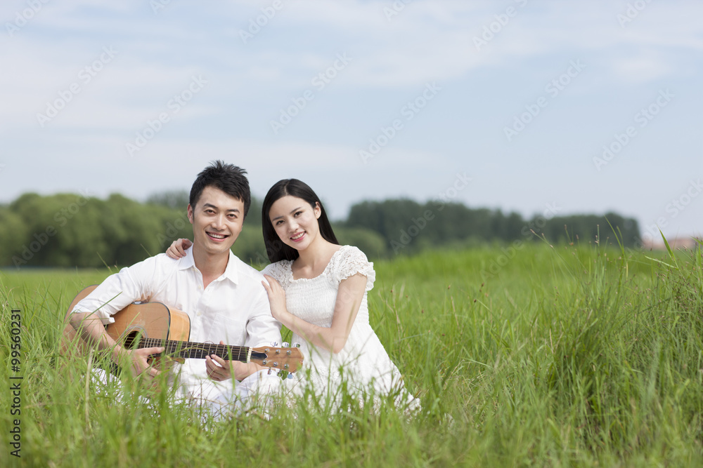 Young couple enjoying music outdoors