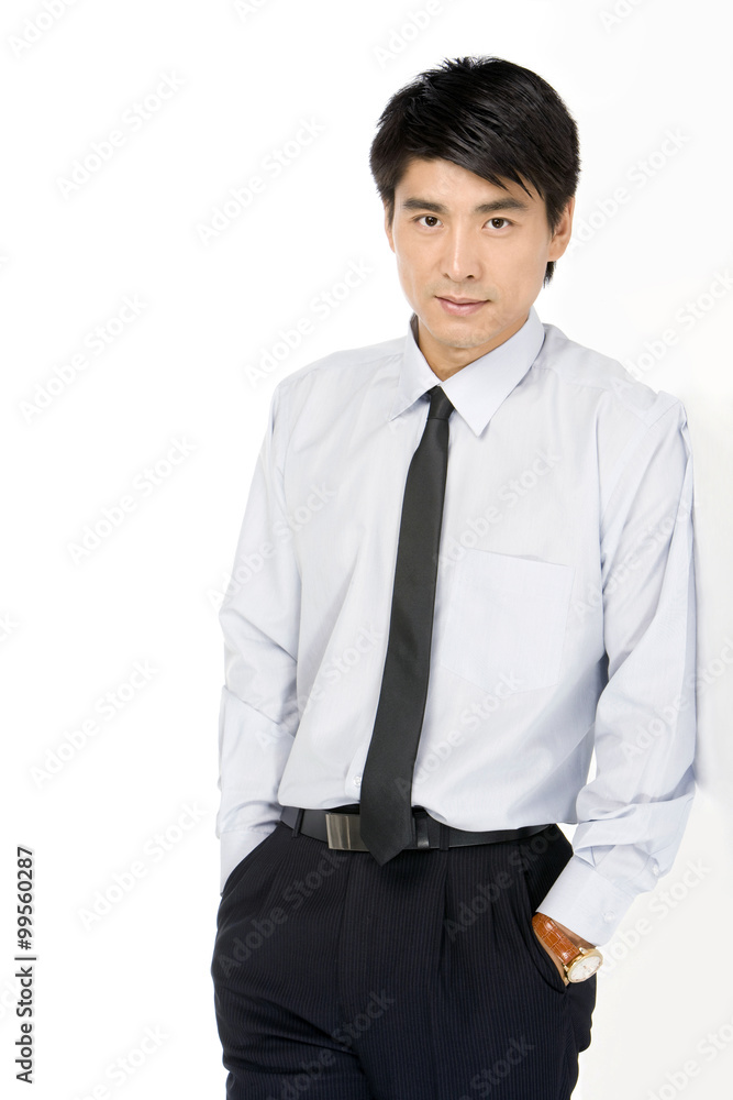 Young Businessman standing against a wall