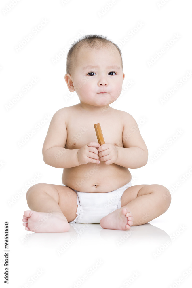 Cute baby boy with biscuit in hand