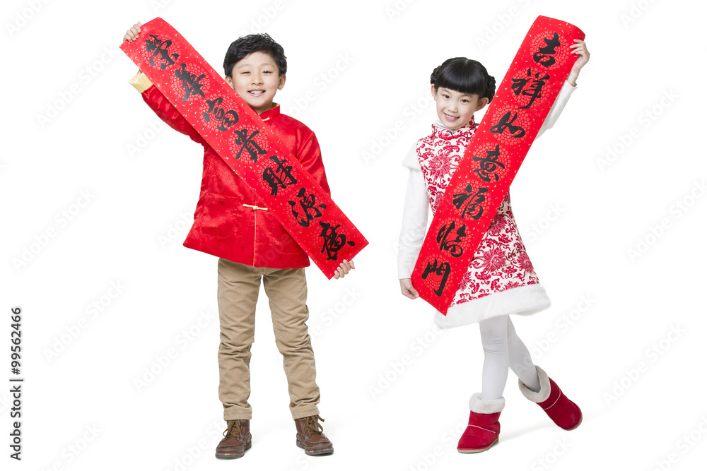 Cute children with couplets celebrating Chinese new year