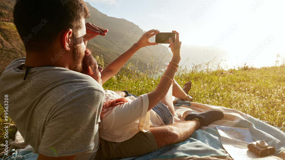 young couple on picnic taking a selfie