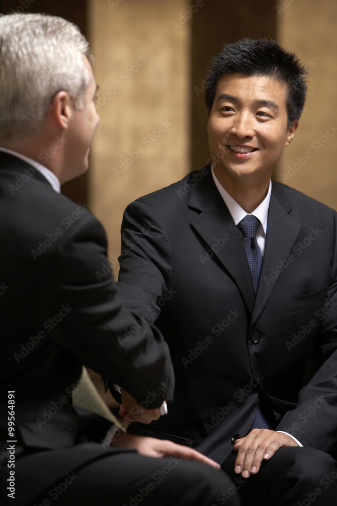 Two business leaders shake hands at an exclusive business club