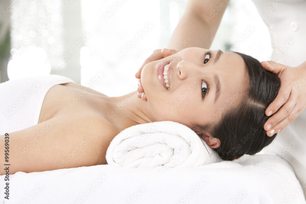 Young woman getting a head massage