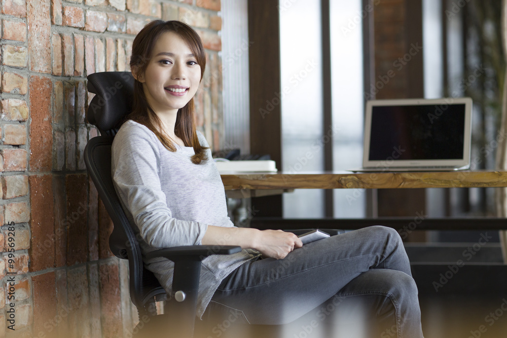 Young woman sitting in office