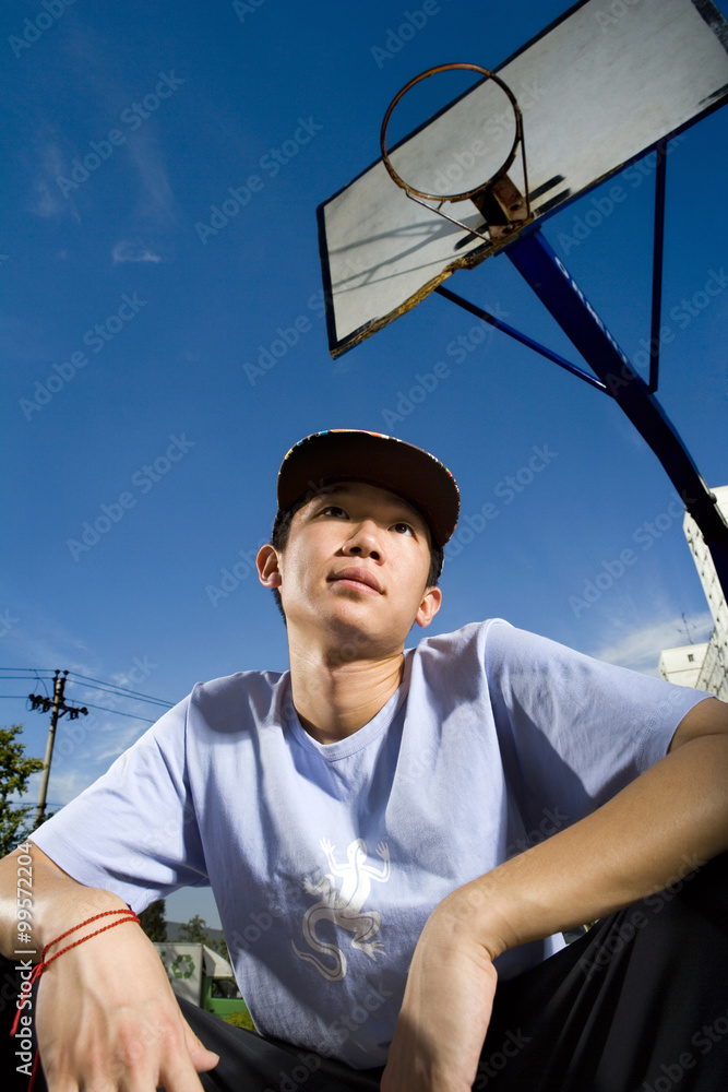 青少年男孩蹲在篮球场上