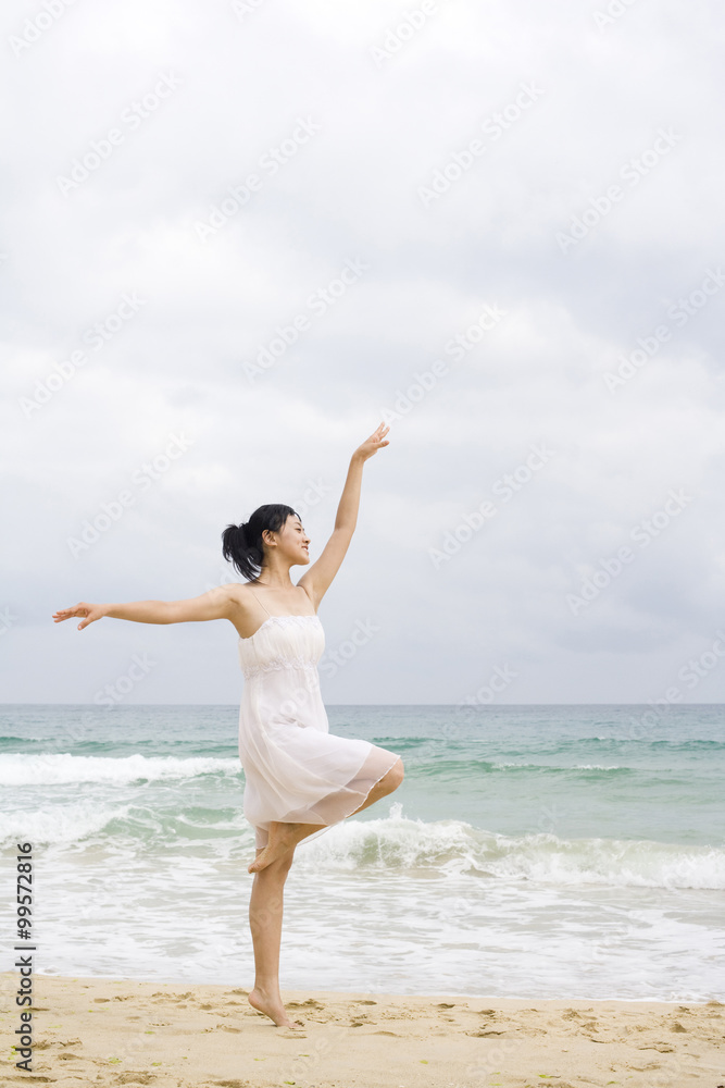 A woman dancing at the beach