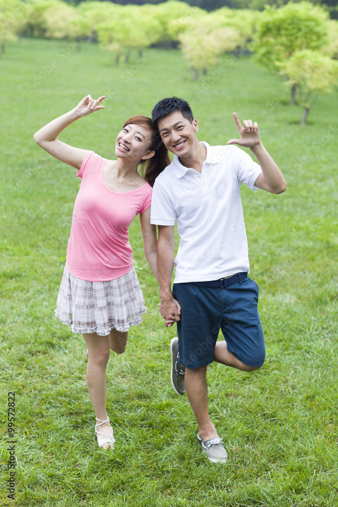 Happy young couple having fun in park