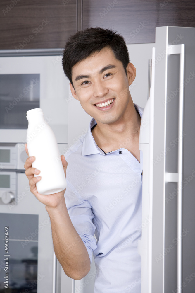 Man taking milk out of the fridge