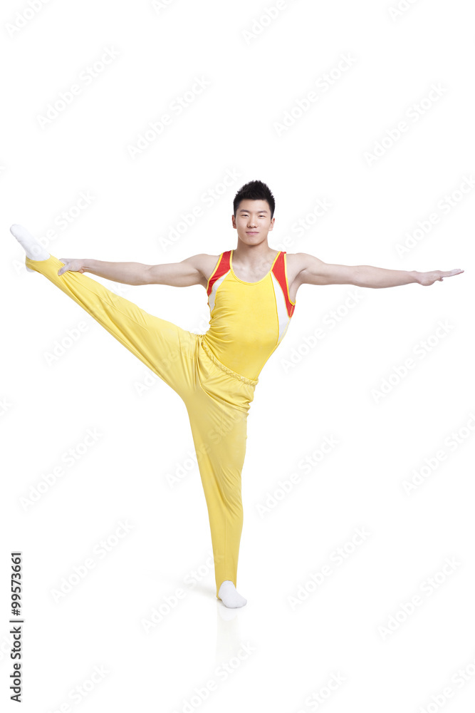 Male gymnastic athlete standing on one leg