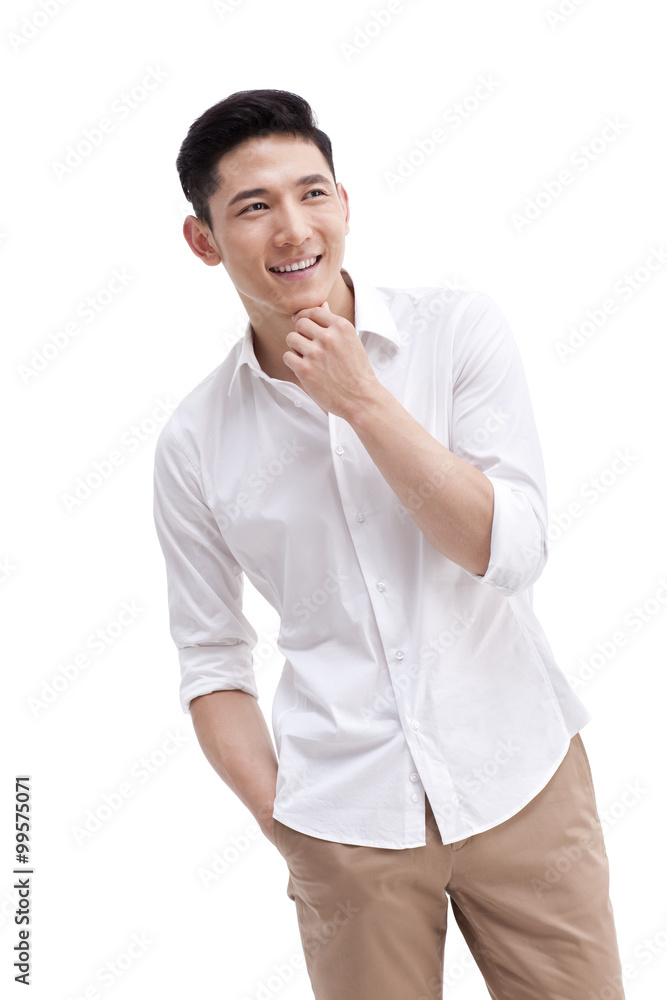 Happy young man with hand on chin