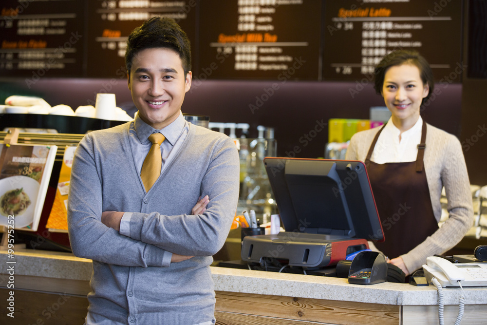 Portrait of coffee store shopkeeper and waitress