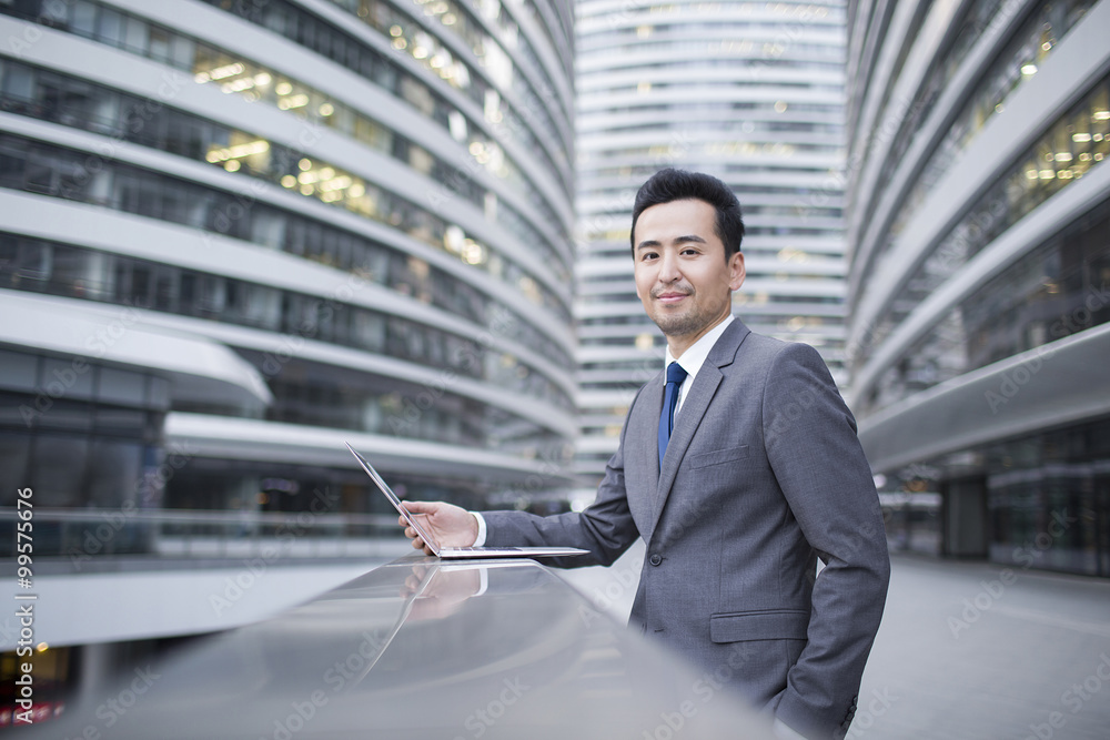 Businessman using laptop outdoors