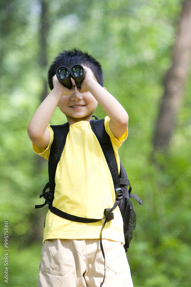 Young boy looking through binoculars