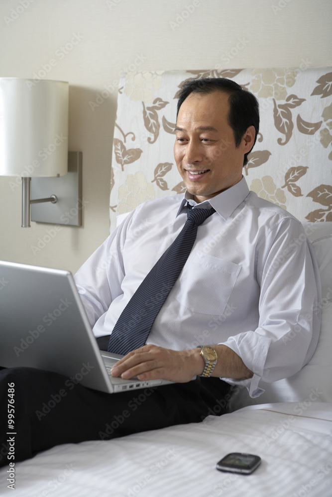 Man in shirt and tie with laptop