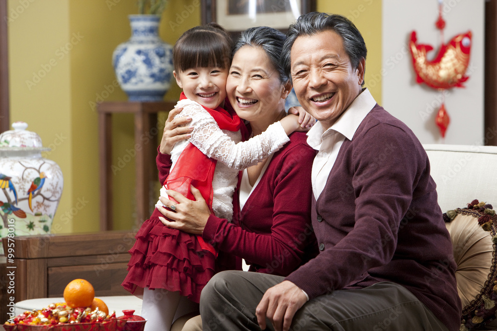 Grandparents embracing granddaughter during Chinese New Year