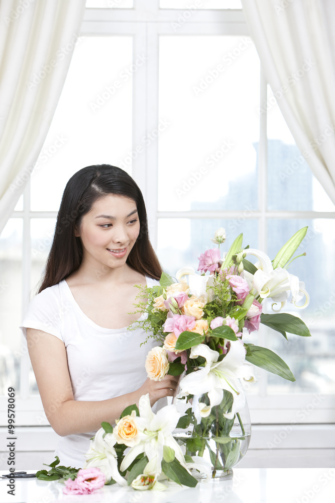 Young woman arranging flowers