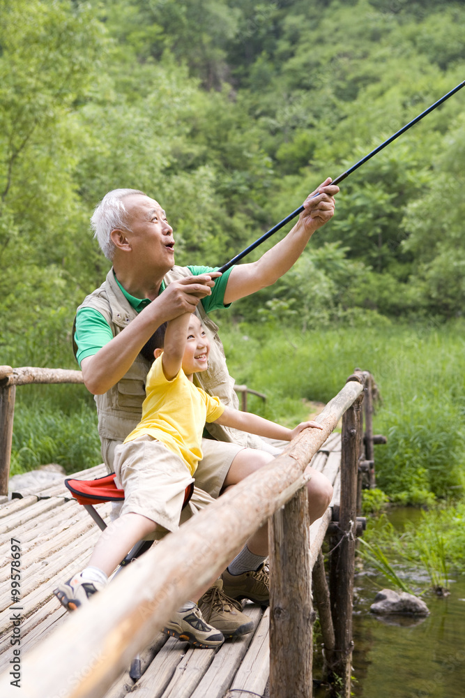 Grandfather and grandson fishing