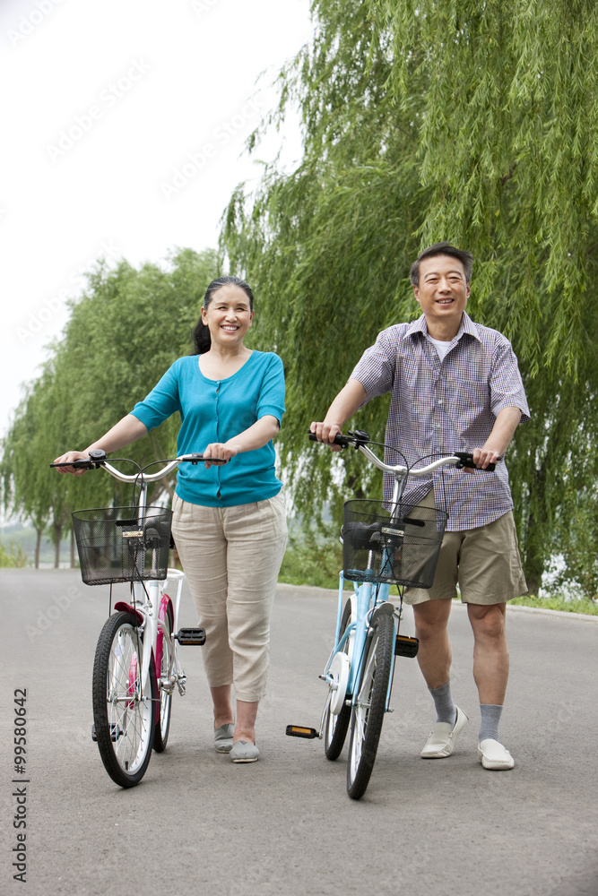 Senior couple cycling in park