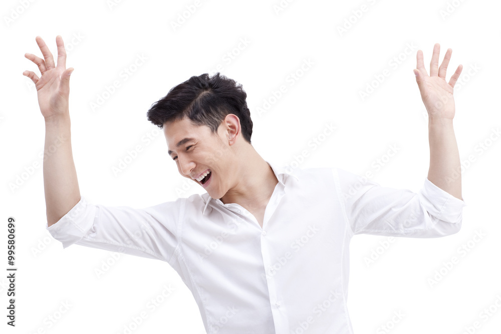 Cheerful young man raising hands