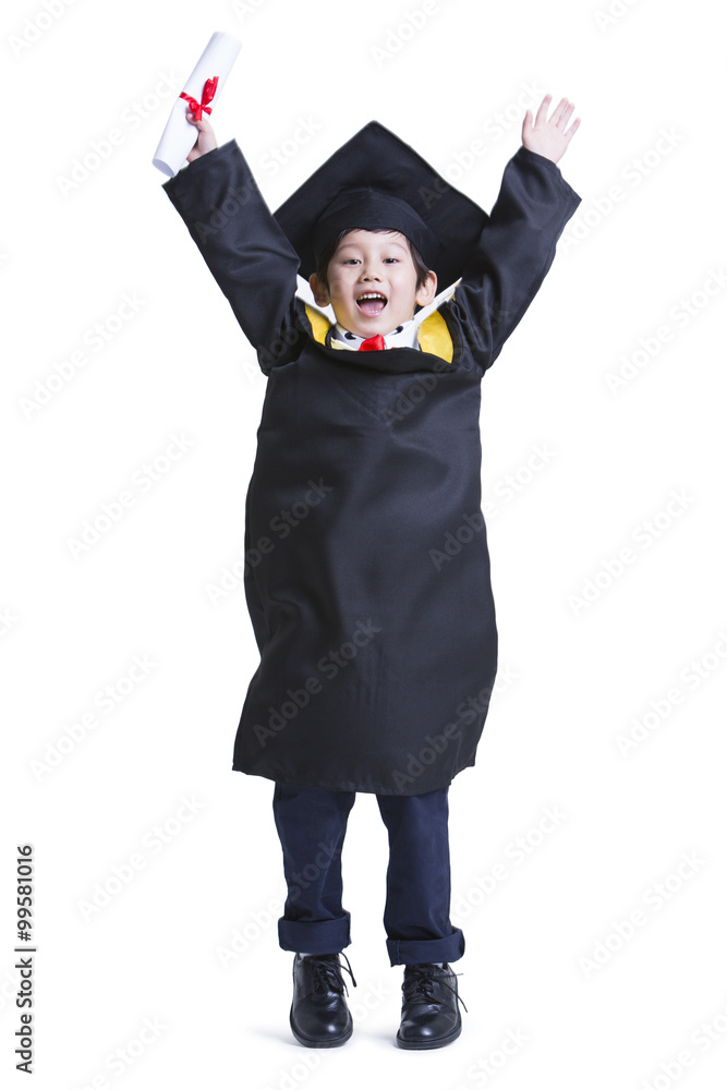 Cute boy in graduation gown celebrating