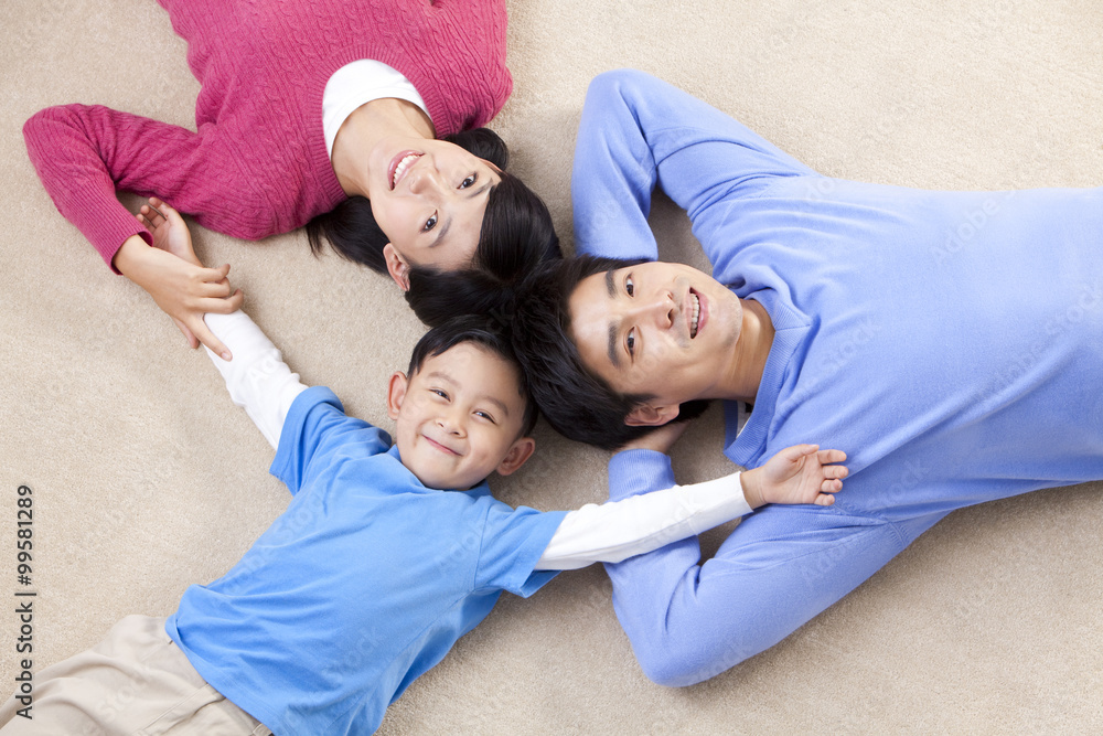 Young Chinese family lying on the floor