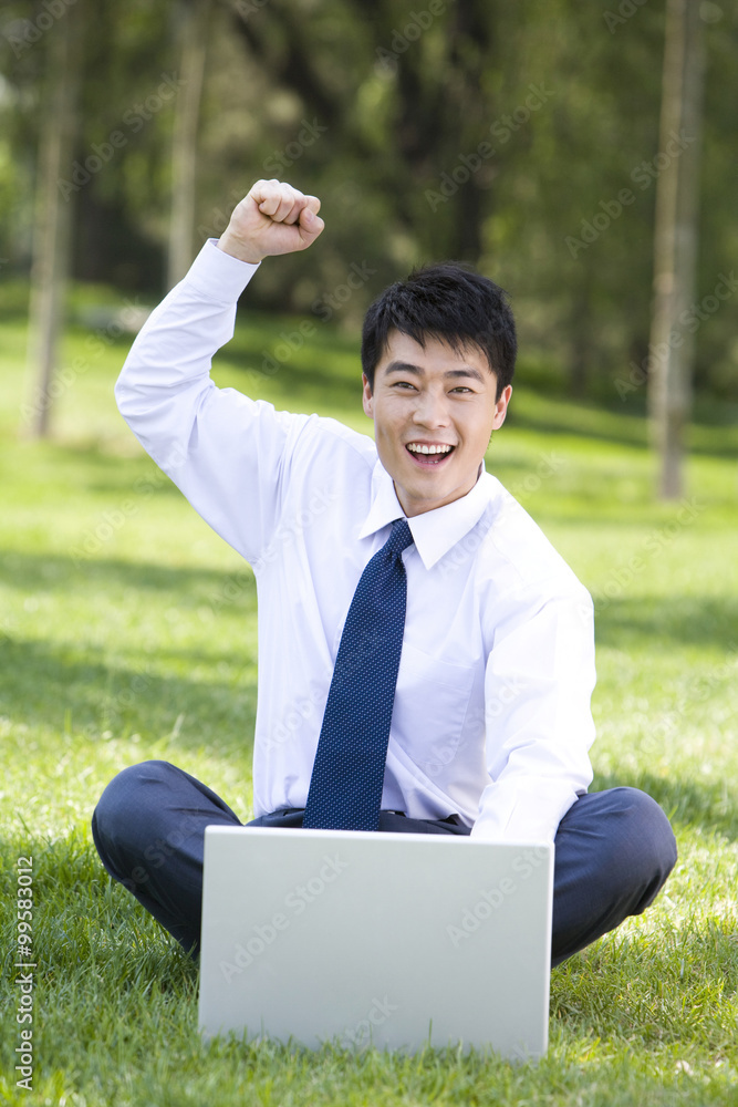 Businessman in the park with laptop