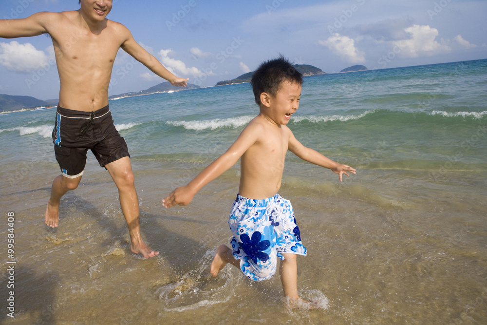 Father and son playing on the beach