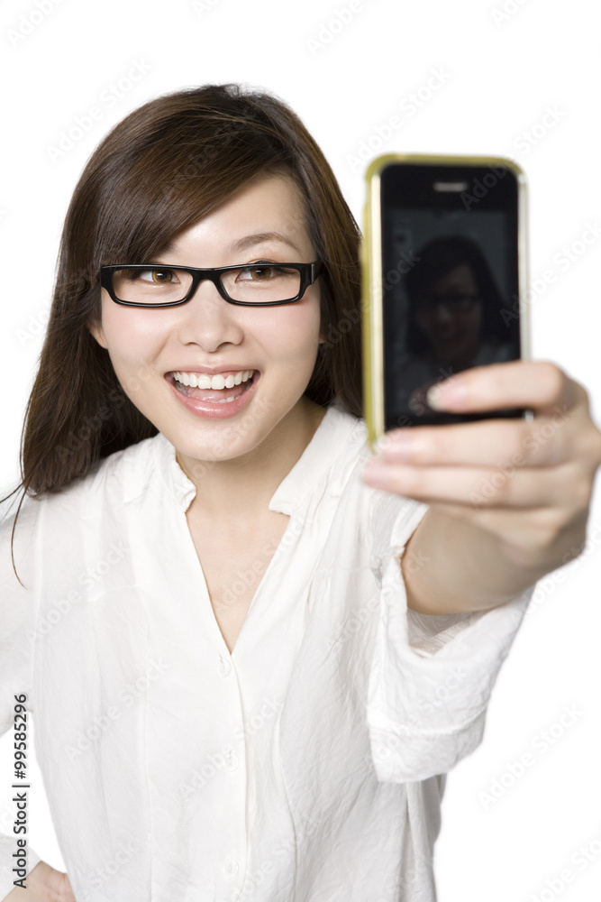 Portrait of Young Woman Taking a Photograph of Herself