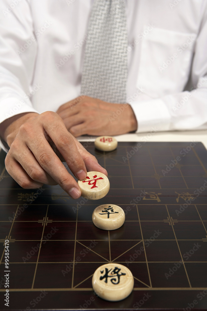 Office worker playing Chinese chess