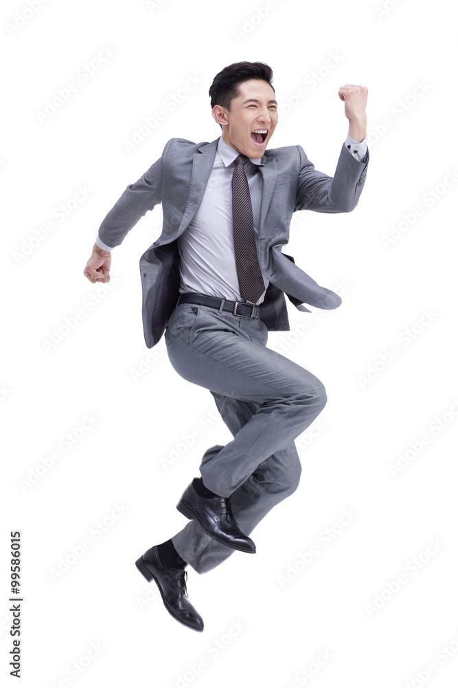 Excited young businessman cheering