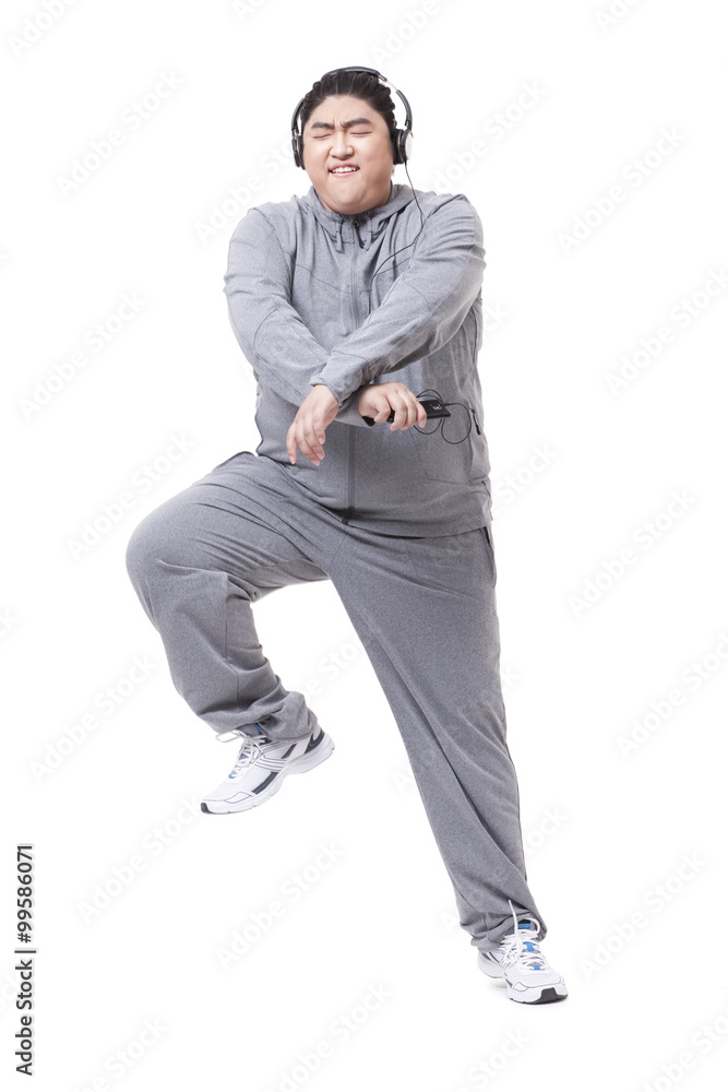 Fashionable Chubby man listening to music and dancing