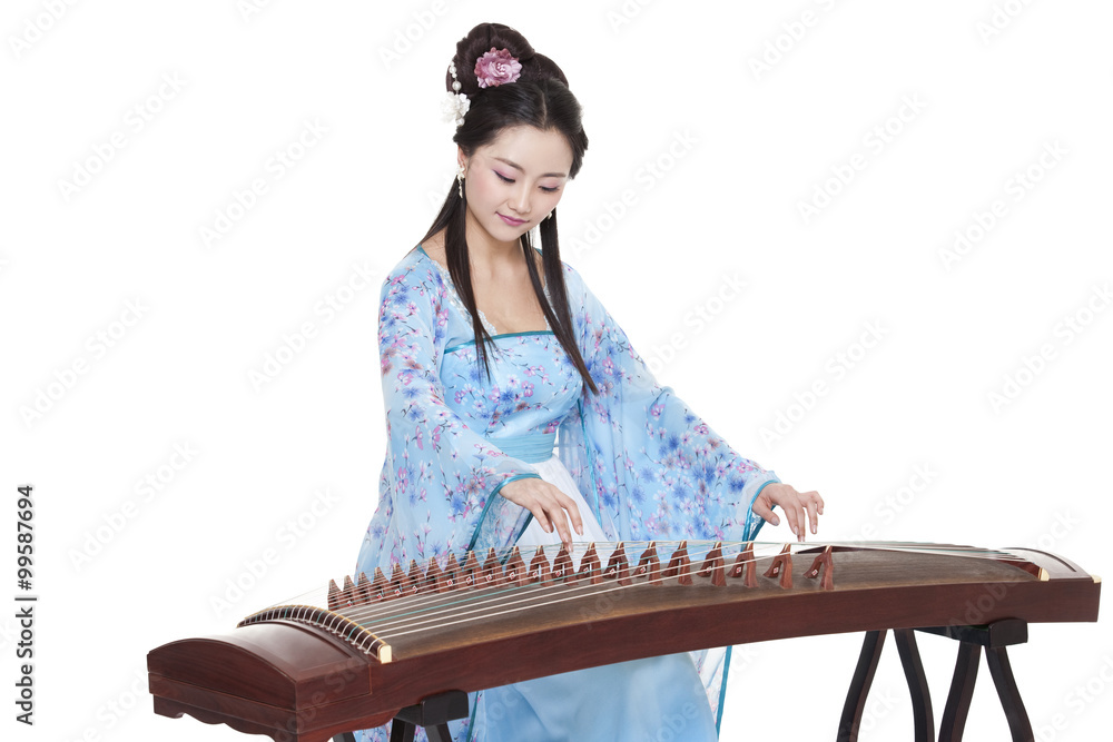 Young woman in Chinese traditional costume plucking Chinese zither