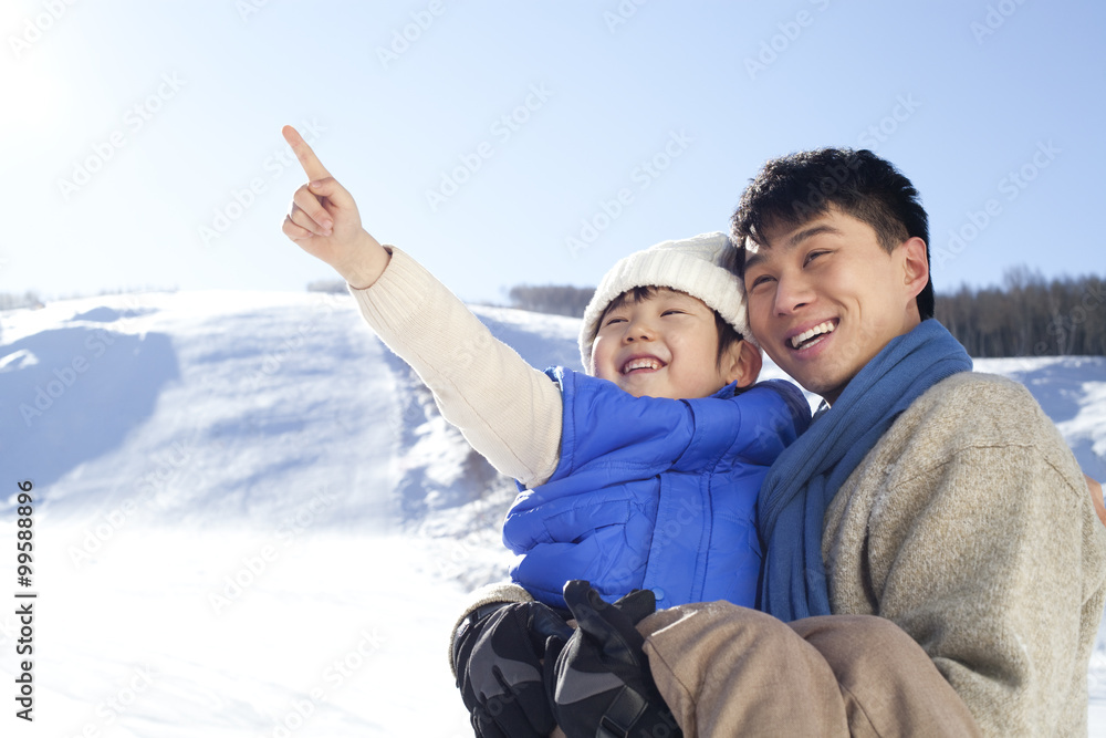 Father playing with son in snow