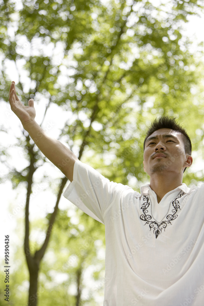 Man Meditating In Park