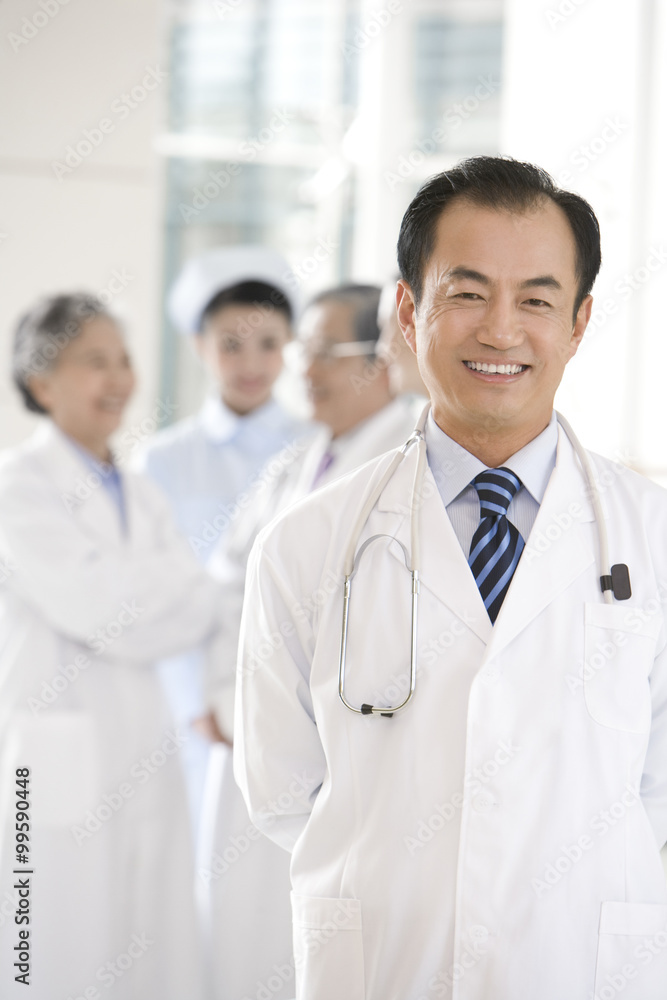 Doctor in Foreground with Doctors and Nurse in Background