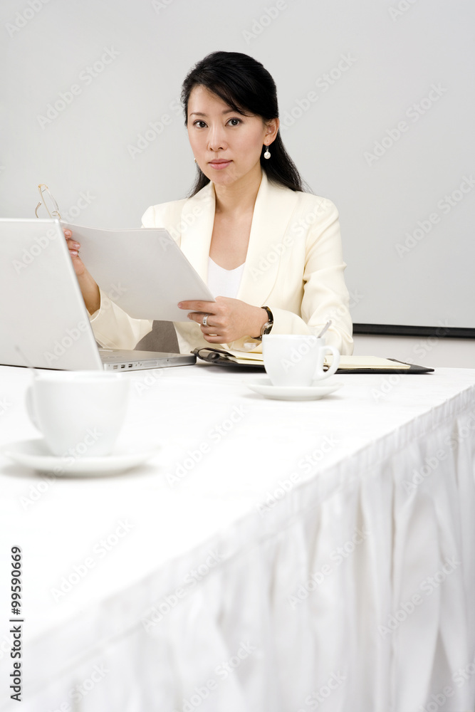 Businesswoman Using Laptop At Dinner Table