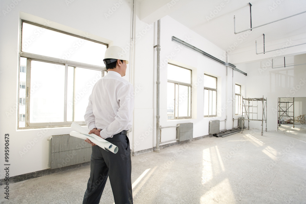 Pensive contractor on construction site