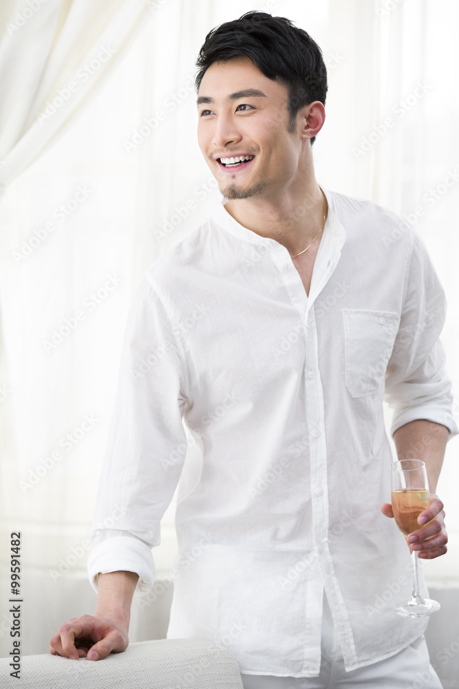 Happy young man with champagne