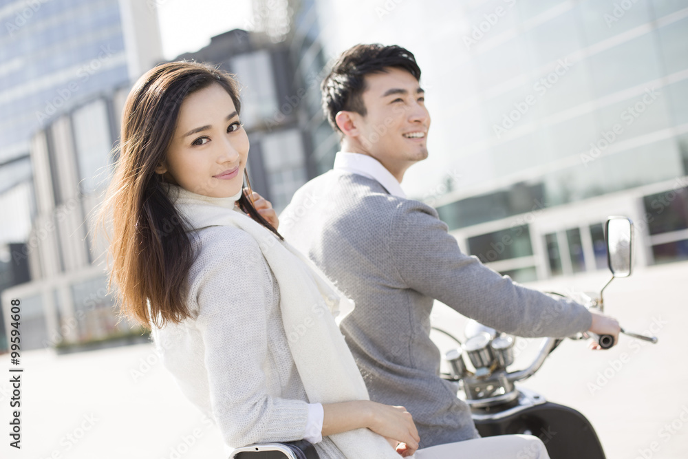 Young couple riding motorcycle together