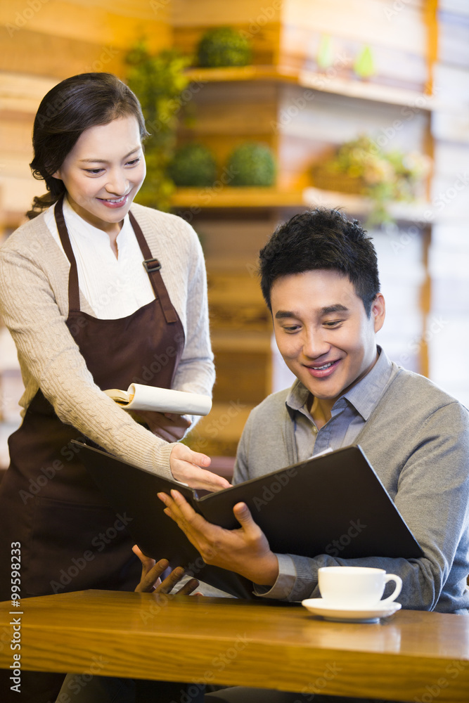 Waitress showing menu to customer