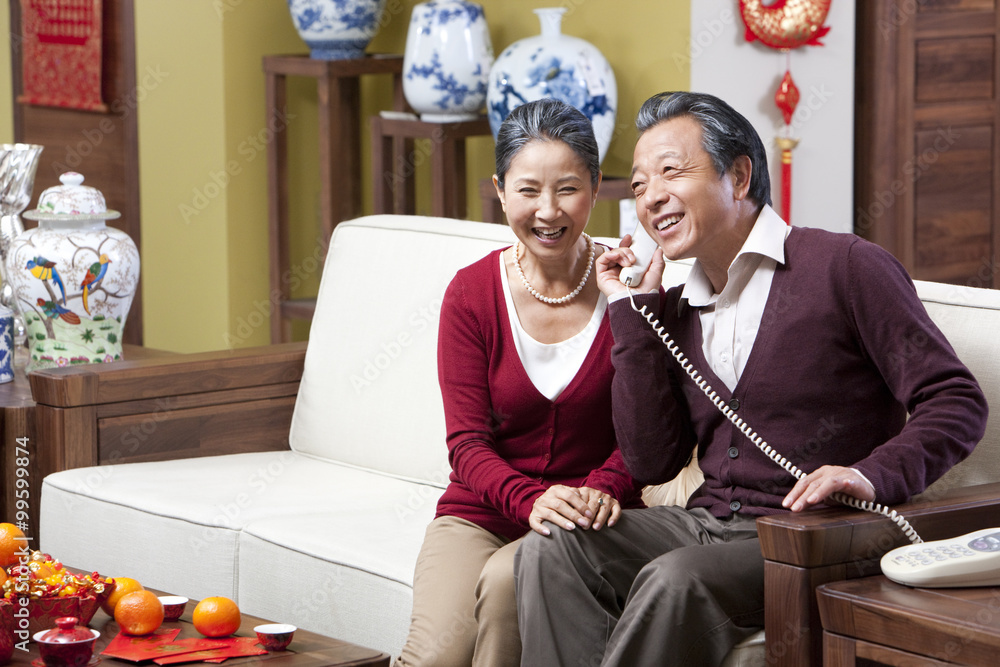 Delighted senior couple on the phone during Chinese New Year