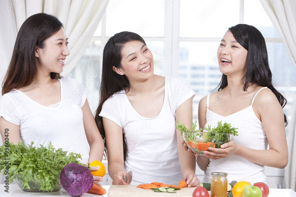 Best female friends preparing salad together